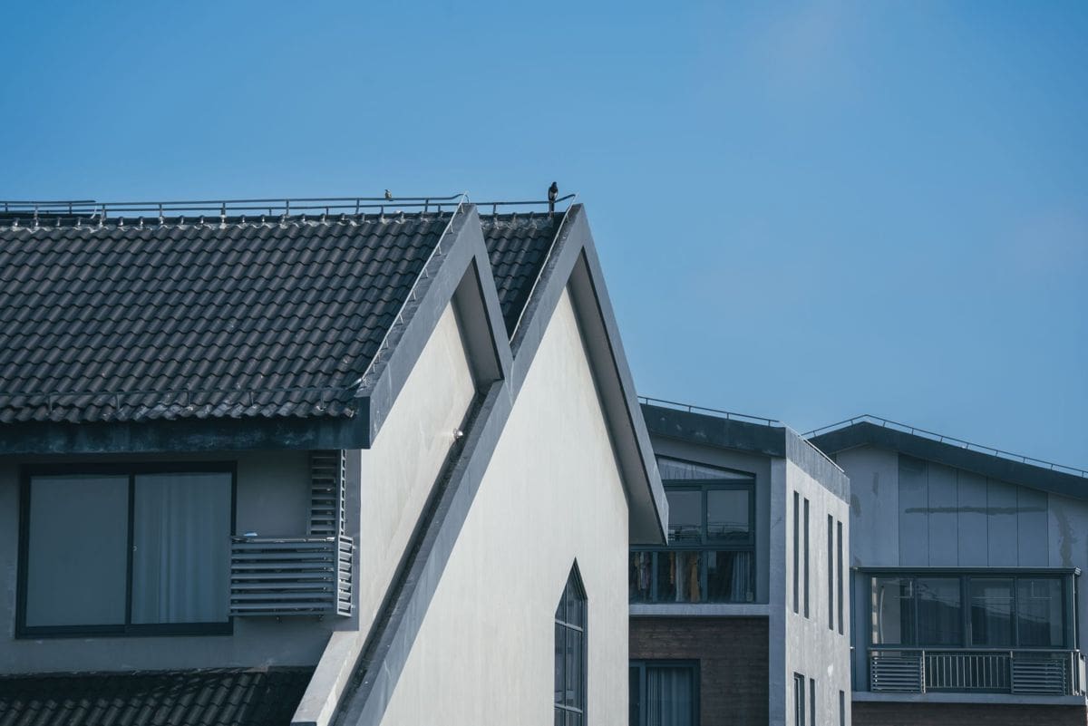 Asphalt shingle roof on a North Texas style home under a clear sky