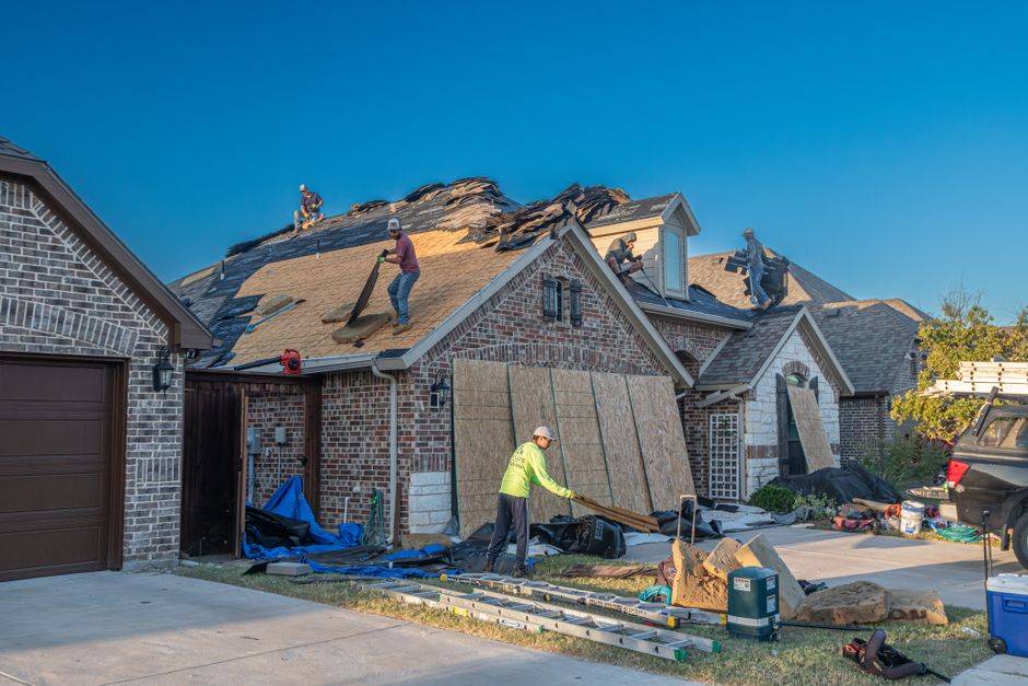 Roof replacement in progress on a North Texas brick home, the kind of job that needs a roof permit in Richardson TX